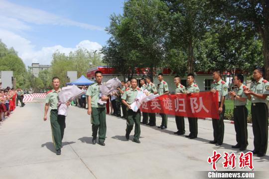 部隊官兵們迎接出院歸來的李運飛(中)和其他消防戰(zhàn)士?！⊥粲?攝